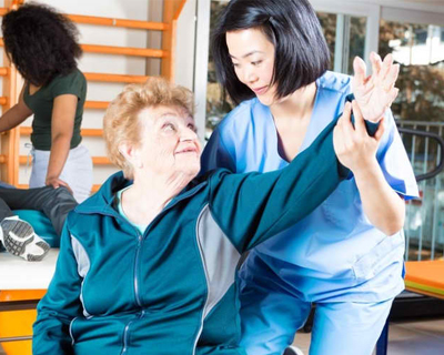 a physical therapist doing therapy to a senior woman