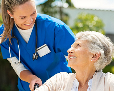 a nurse assisting a senior woman