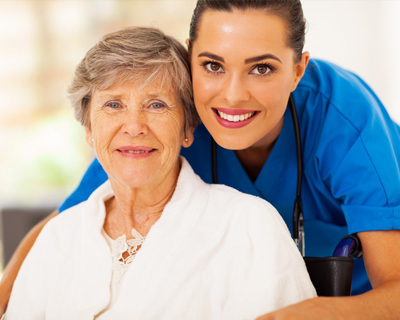 a nurse and a senior patient smiling