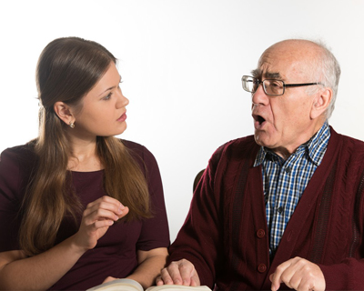 a speech therapist and a senior man doing speech therapy