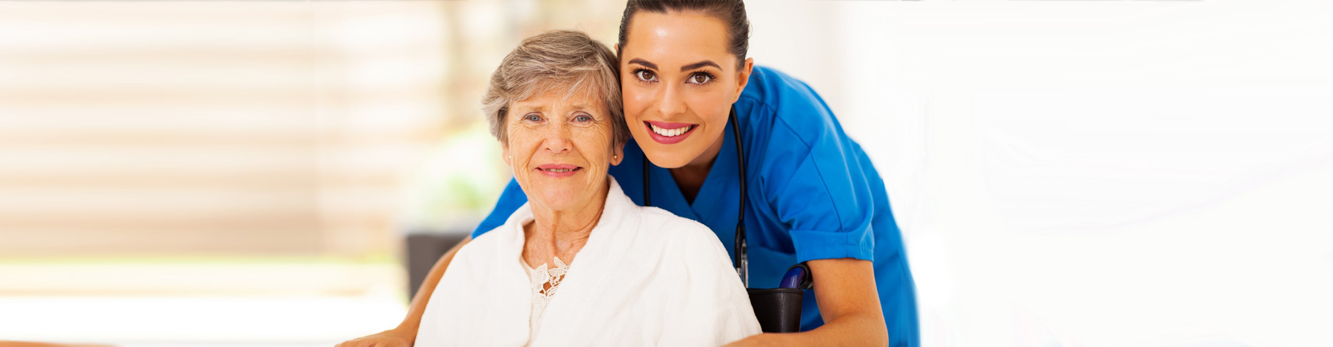 a nurse and a senior patient smiling