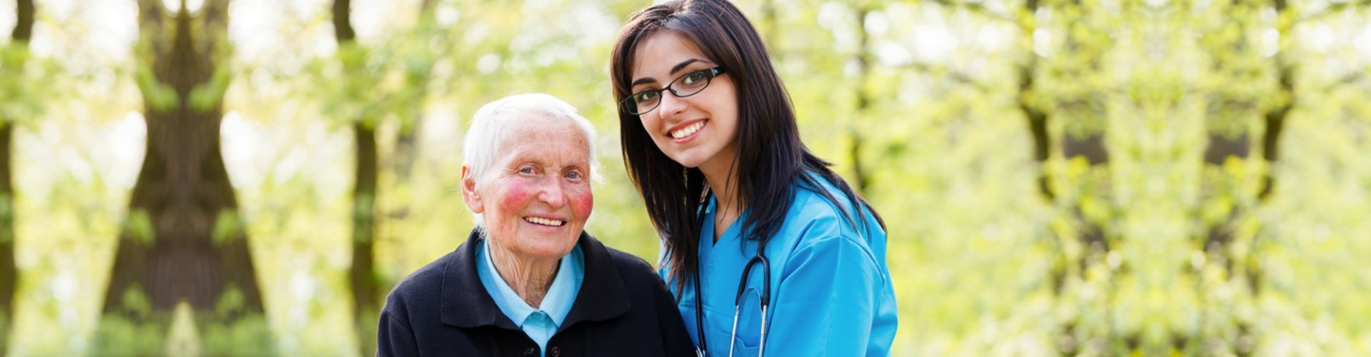 a nurse and a senior woman taking a walk outside